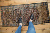 Vintage Farahan Sarouk runner's Herati pattern with sapphire blue abrashes underfoot.