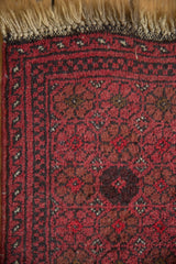 Vintage Afghan sampler rug corner: beige fringe, red floral field, and dark vine border.