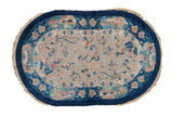 Oval vintage Nichols Art Deco rug with peacocks, blue pictorial border, and ivory field.