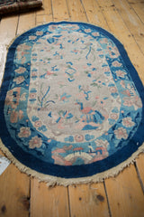 Ivory central field of the Art Deco rug, showing diamond lattice, blue cloud bands, and peacocks.