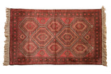 Vintage Belouch rug featuring serrated geometric guls in raspberry red and aubergine, 2'8