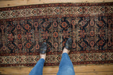 Aged vintage Hamadan runner: dark navy geometric Herati and stacked henna border.
