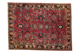 Hand-knotted vintage Sarouk rug featuring a cherry red field and sapphire blue palmettes.