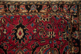 Vintage Persian Sarouk rug's cherry red field with sapphire palmettes and black scrolling vines.