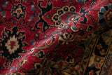 Folded Sarouk rug: plush cherry red pile, black, sapphire palmettes and serrated leaves.