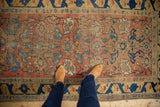 Antique Halvai Bijar runner's worn Harshang motif in red and blue, with rare yellow border.