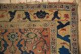 Saffron yellow border of antique Bijar rug, highlighting cobalt blue vine motif and wear.