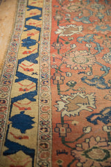 Antique Halvai Bijar rug's rare yellow border with deep cobalt vine and worn red floral field.