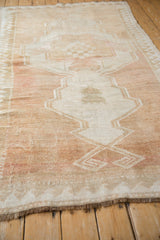 Vintage Distressed Oushak Rug, textured ivory and pale copper asymmetric medallion.
