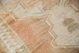 Even, short pile texture of a vintage distressed Oushak rug in pale copper and ivory.