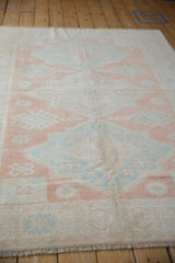 Distressed vintage Turkish Oushak rug pile with cantaloup, mint, and ivory geometric patterns.