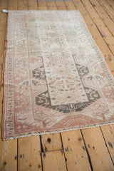 Distressed vintage Melas runner detail with beige, pale pink, oxidized silver geometric patterns.