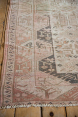 Distressed Melas runner side border with geometric patterns, dusty rose, and even wear.