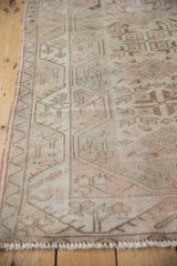 Geometric patterns and soft, distressed texture on a vintage Melas rug runner.