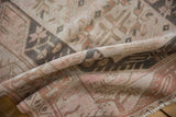 Distressed Melas rug texture in beige, pale pink, and dark oxidized silver tones.