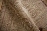 Vintage distressed Afghani Bokhara rug texture with beige, sand, and soft pink guls.