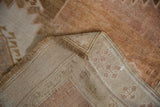 Reverse side of the distressed Oushak rug, showing hand-knotted foundation and intact selvage.