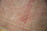 Distressed texture of vintage Shiraz carpet, revealing worn knot heads and blush beige tones.