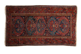 Vintage Persian Mehreban rug, raspberry red field with blue cloudband medallion motifs.