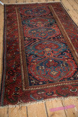 Raspberry red field, cobalt blue cloudband motifs, and floral vine border of a vintage Mehreban rug.