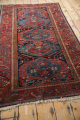 Vintage Mehreban rug with raspberry red cloudband motifs and a blue-green floral border.