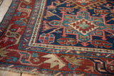 Karaja rug's geometric field, checkered blossoms, and arabesque border in navy, cherry red.