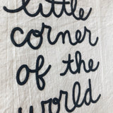 Close-up detail of 'little corner' black raised script on natural unbleached cotton banner.