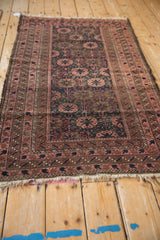 Tattered fringe and geometric minor borders of a vintage Belouch rug, circa 1920s.