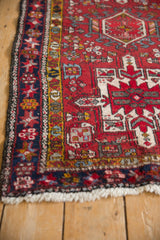 Intact side cord selvage and geometric navy border on a vintage hand-knotted Karaja rug.