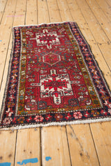 A vintage Karaja rug viewed from an angle, highlighting the progression of its triple medallions.