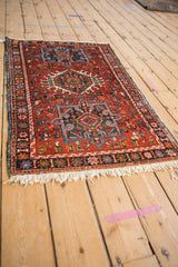 Full length perspective of a fine vintage Karaja rug with its cherry red and blue geometric design.