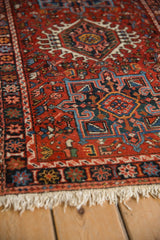 Close view of a vintage Karaja rug's hook-and-latch medallion and colorful starburst border design.