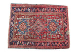 Vintage Karaja rug with checkered medallion, geometric field, in brick red and navy.
