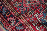 Dense hand-knotted Karaja rug pile, displaying geometric blossoms, pinwheels in red and blue.