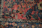 Dense, plush pile of vintage Lilihan rug showcasing raspberry red and sapphire blue florals.