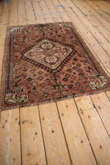 Kamseh rug's border and field, showing faded brick red and dark brown motifs.