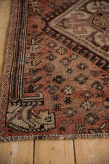 Vintage Kamseh rug pile in faded brick red with dark chocolate floral blossoms.
