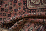 Kamseh rug's hand-knotted pile close-up, revealing muted red, brown, ivory tones, and fringe.