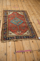 A full perspective view of a fine antique Heriz rug, highlighting its geometric layout and storied condition.