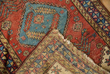 A folded corner on a fine antique Heriz rug reveals its hand-knotted foundation.