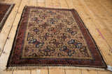 Angled view showing the geometric pattern and texture of a vintage hand-knotted Belouch rug.