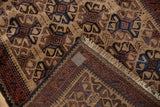 Corner of a vintage Belouch rug folded to show its hand-knotted pile and woven foundation.