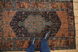 Vintage Hamadan rug featuring navy blue medallion and lattice, dusty blush, apricot tones, and even wear.