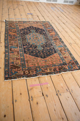 Hand knotted Persian Hamadan rug close-up: navy, sky blue, blush geometric border design.