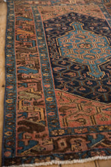 Vintage Hamadan rug close-up, dusty blush geometric border, navy field elements, even pile wear.