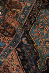 Vintage Hamadan rug pile displaying navy, sky blue, dusty plum, and blush geometric patterns.