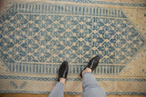 Distressed Malayer rug, faded denim blue trellis on ivory, showing even wear.