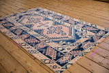 Distressed blush and navy blue vintage Melas rug border with serrated leaf and hook motifs.