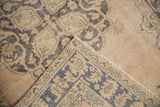 Mostly even wear on distressed beige pile and patterned foundation of vintage Sparta rug.
