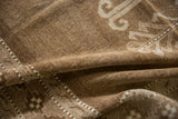 Rich texture of distressed Kars carpet, brown and ivory geometric ram's horn and checkered patterns.